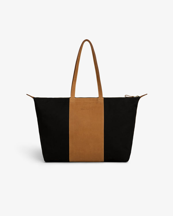 Leather Canvas Zip Tote with black sides, brown center panel, and matching brown handles.