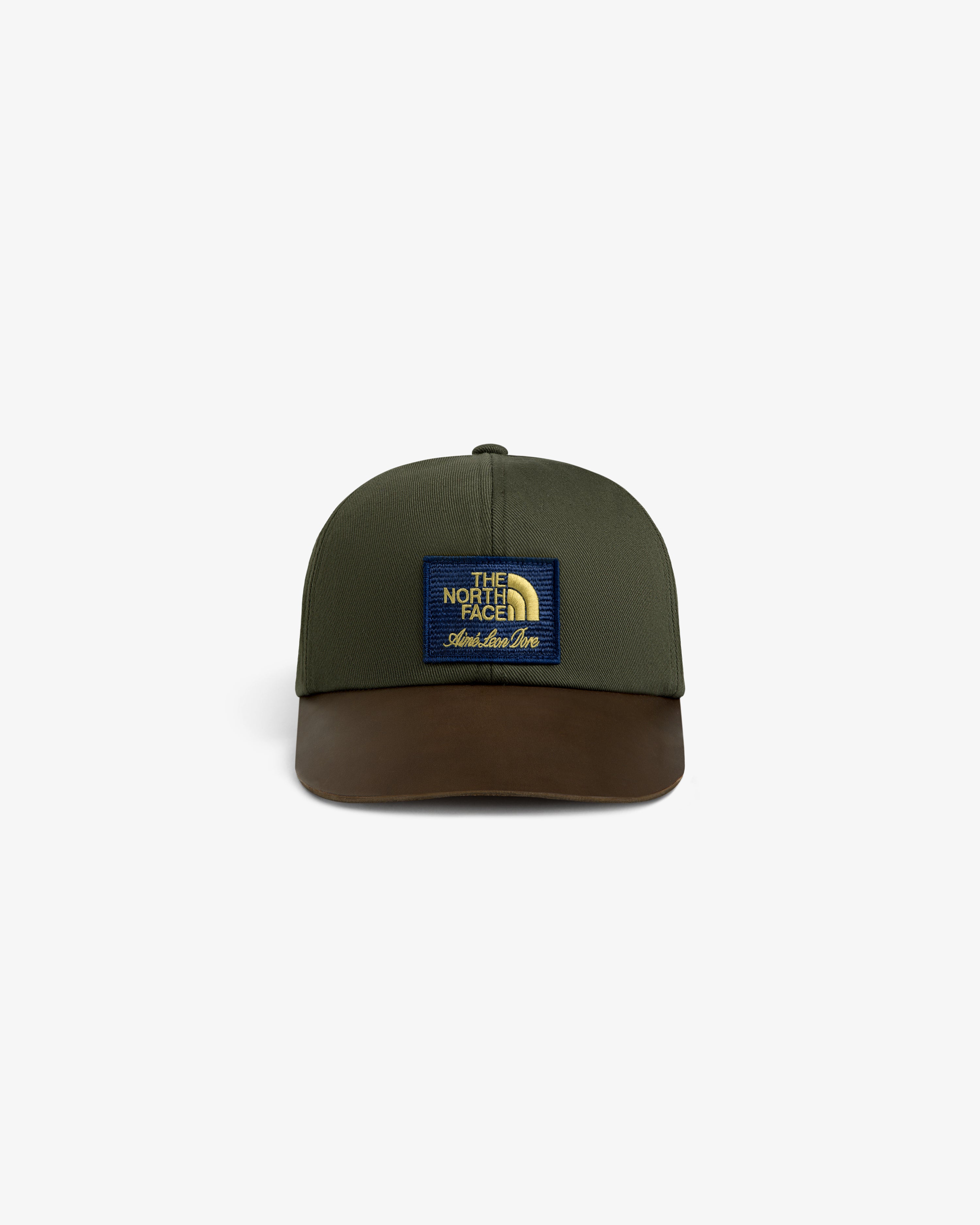 ALD / The North Face Leather Brim Logo Hat in olive with brown brim and logo patch, shown on white background.