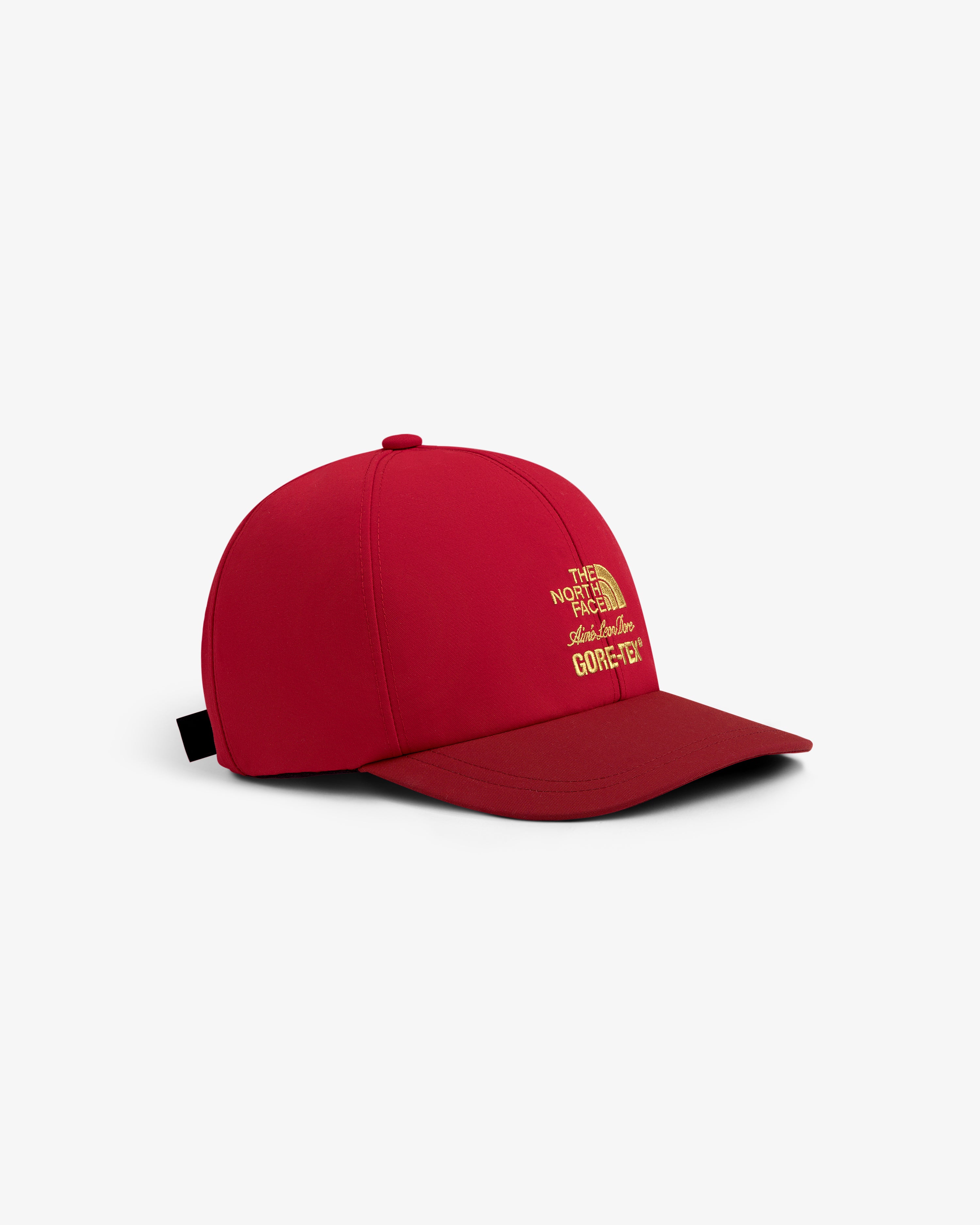 ALD / The North Face GORE-TEX Hat in red with yellow logos, shown on a white background.