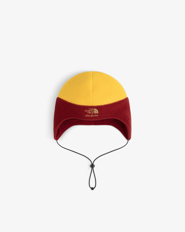 ALD / The North Face Fleece Earflap Hat in yellow and red, with ear flaps, chin strap, and front logo.
