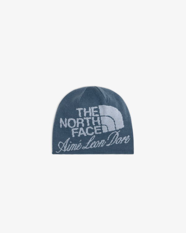 ALD / The North Face Jacquard Beanie in blue with white logos on the front.