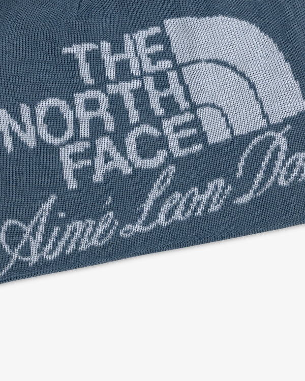 Blue knit ALD / The North Face Jacquard Beanie with logo and white Aime Leon Dore script text.