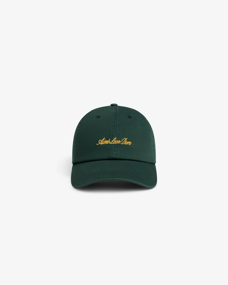 Washed Script Chino Hat in dark green with gold Aimé Leon Dore text, displayed on a white background.