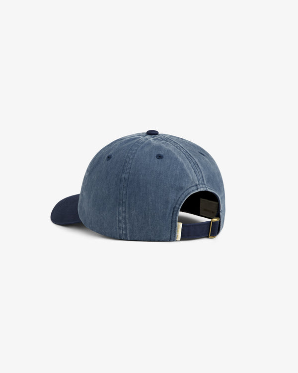 Back view of the Pigment Dyed Logo Hat in blue denim with adjustable strap and metal buckle on white background.