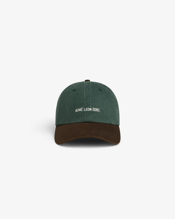 Pigment Dyed Logo Hat: Green cap with brown brim, AIMÉ LEON DORE in white embroidery on the front.