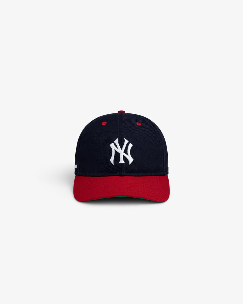 ALD / New Era Yankees Retro Fit Hat: a navy blue baseball cap with a red brim and a white NY logo on the front.