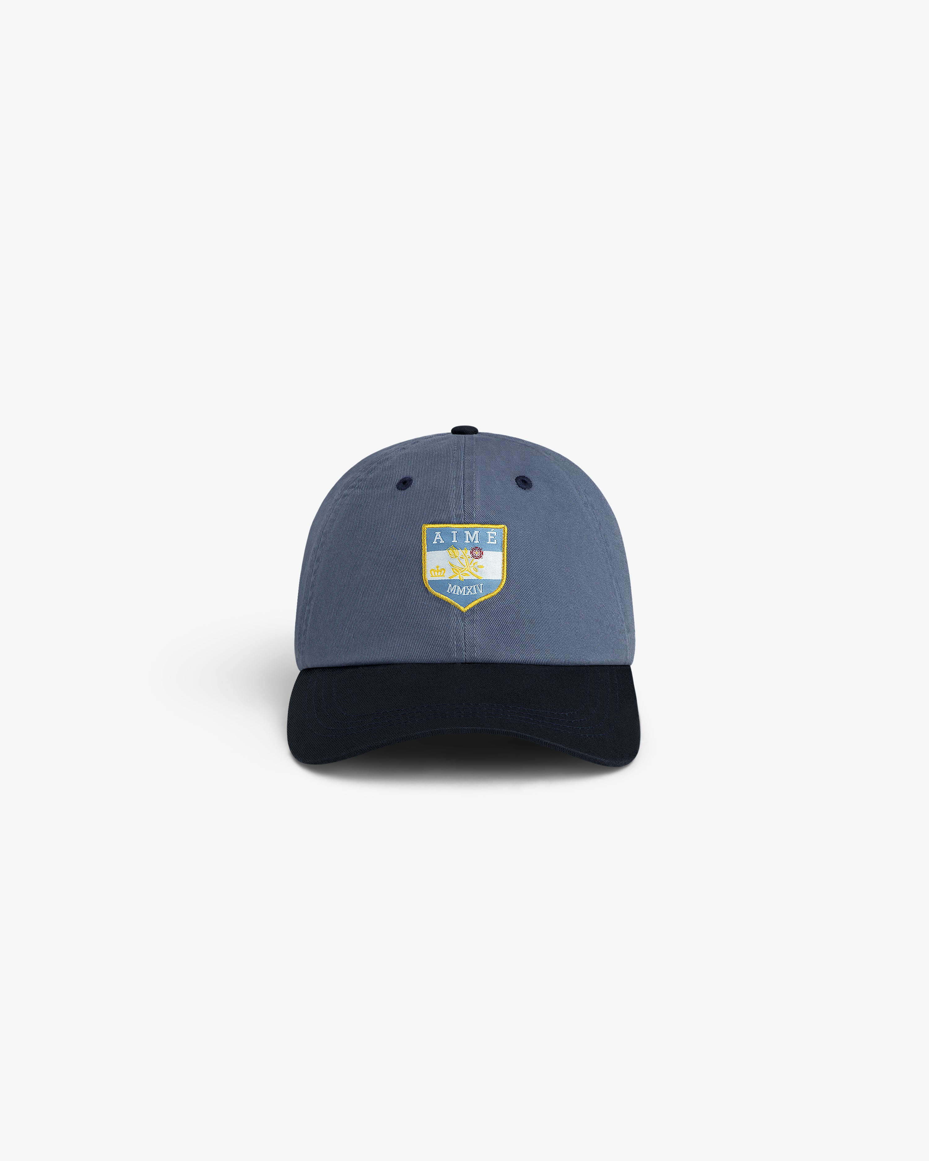 Crest Shield Hat: Blue cap with black brim, yellow-blue AIME LEON DORE HARVEST shield logo on the front.