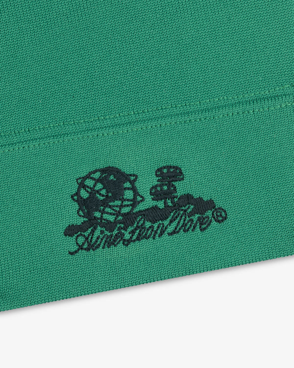 Green Unisphere Skull Cap with black globe, mushrooms, clouds, and “Aint Lion Kin” in cursive.