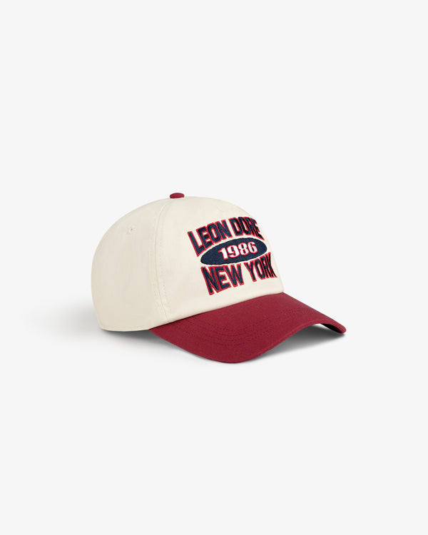 Colorblock Club Hat in cream and maroon with “Leon Dore 1986 New York” embroidered on the front.