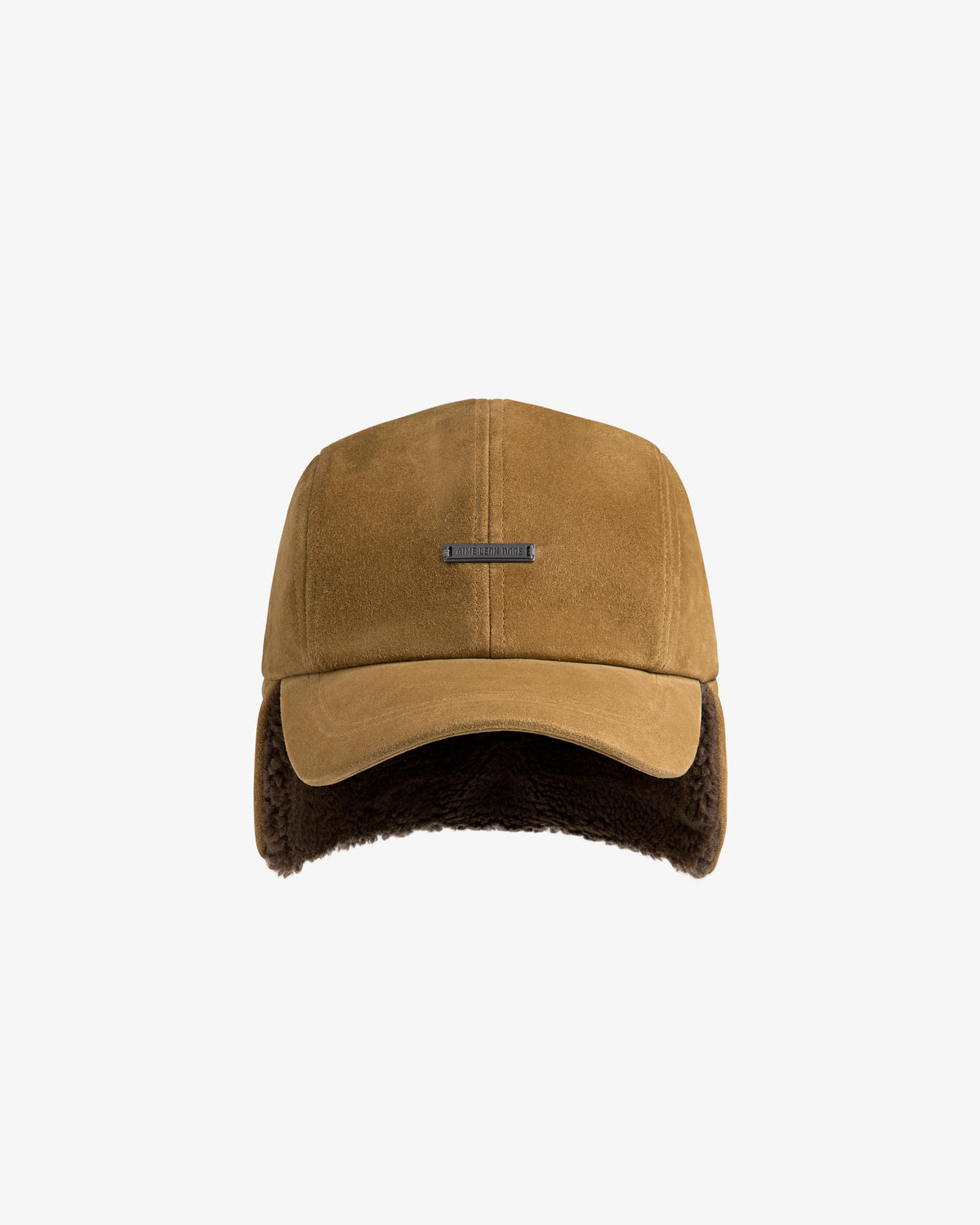 Shearling Earflap Hat in tan suede with a metal logo plate and dark brown fur-lined earflaps.
