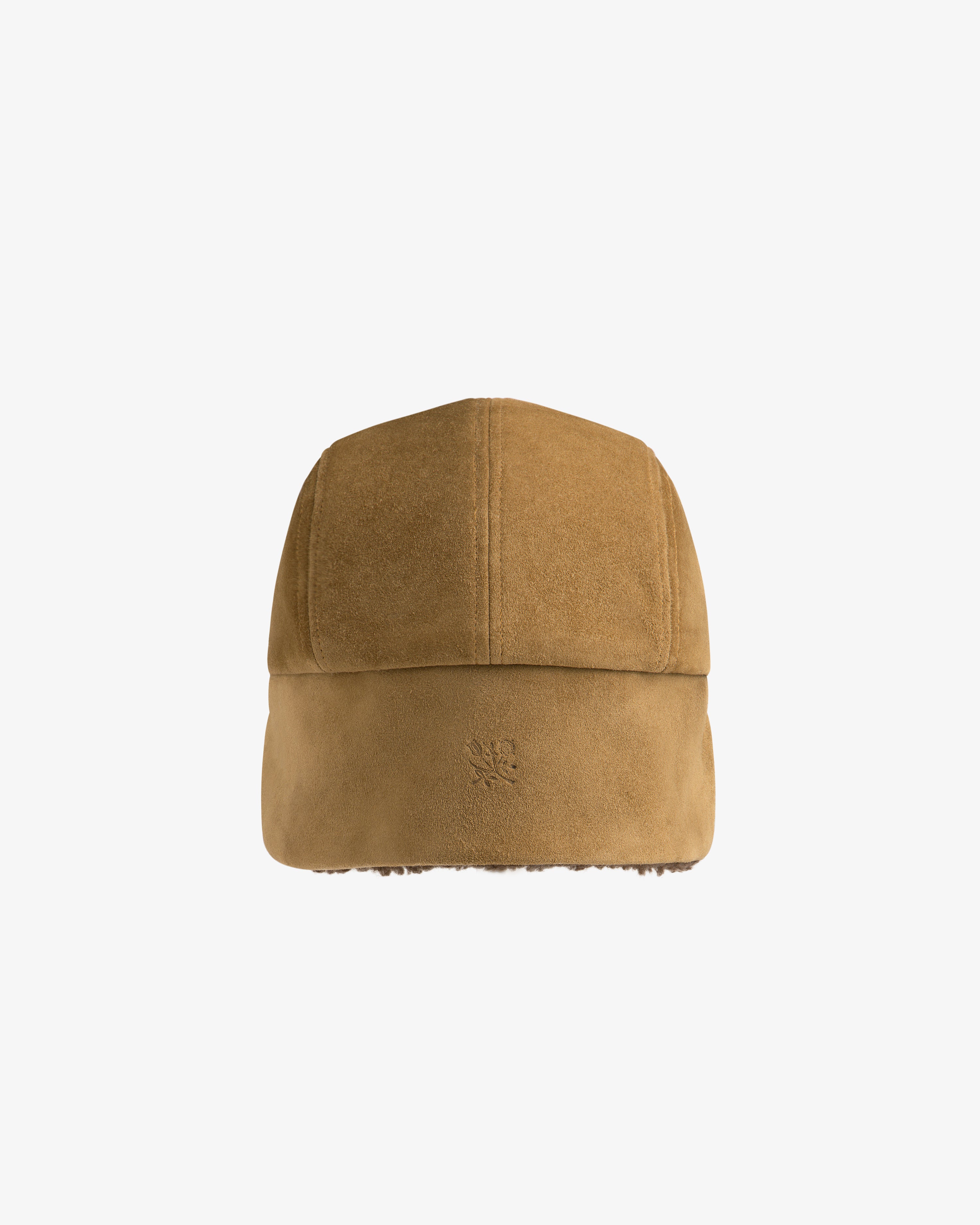 Brown suede Shearling Earflap Hat with earflaps and a small embossed logo on the side.