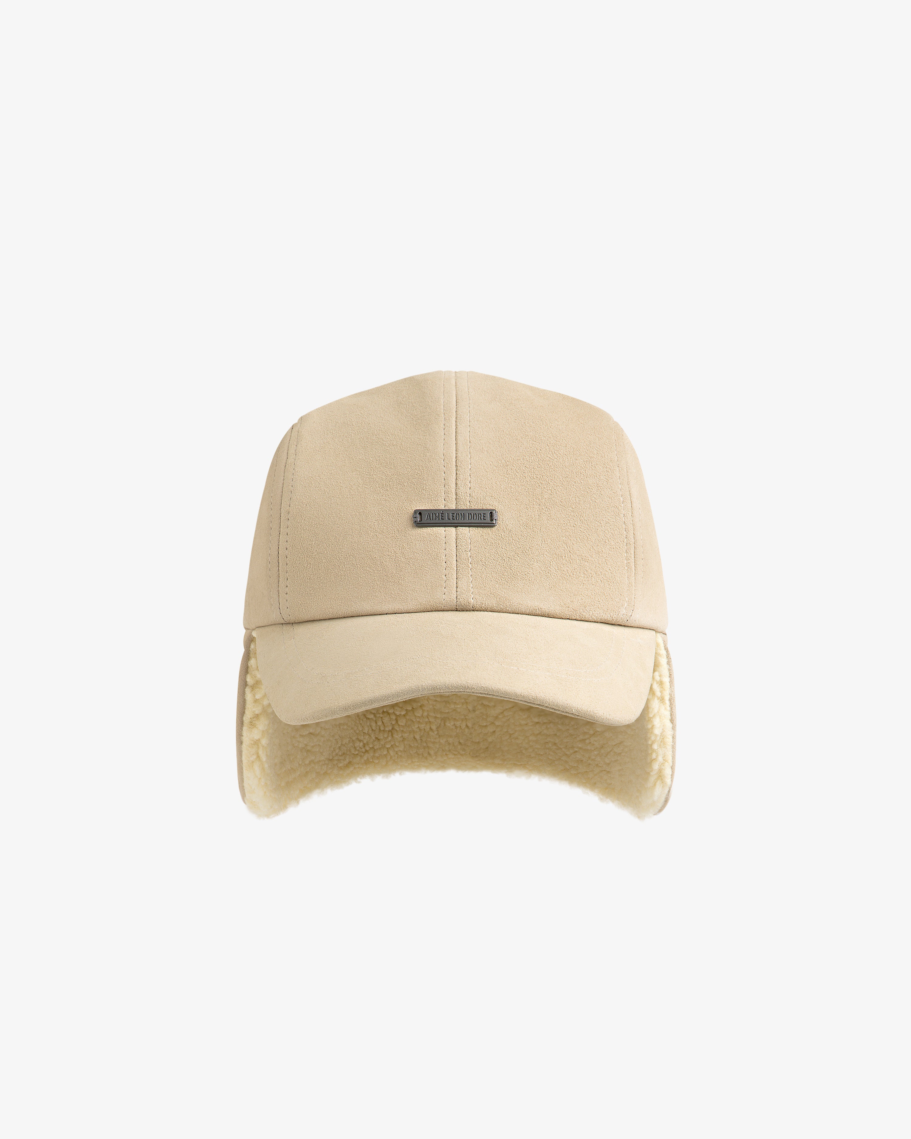 Shearling Earflap Hat: a beige suede baseball cap with earflaps lined in cream-colored fleece.