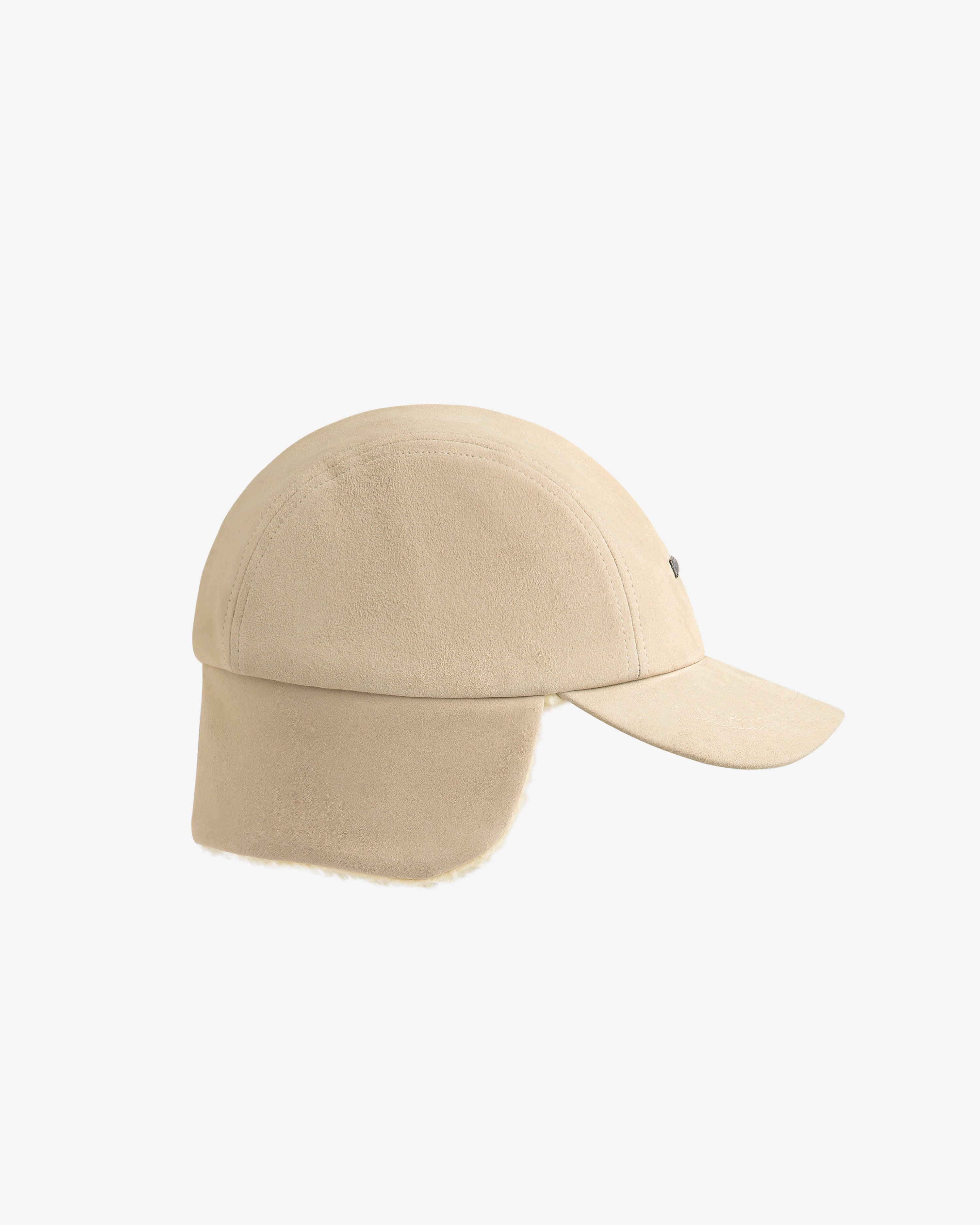 Shearling Earflap Hat: a tan suede baseball cap with fold-down earflaps lined with light-colored fleece.