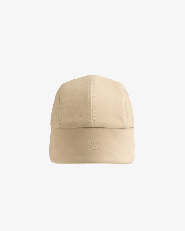 Beige suede Shearling Earflap Hat with a small embossed logo on the front.