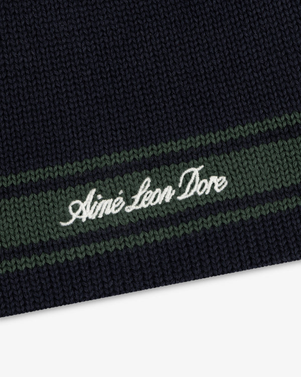 Navy Stripe Knit Beanie with green stripes and Aimé Leon Dore embroidered in white cursive.