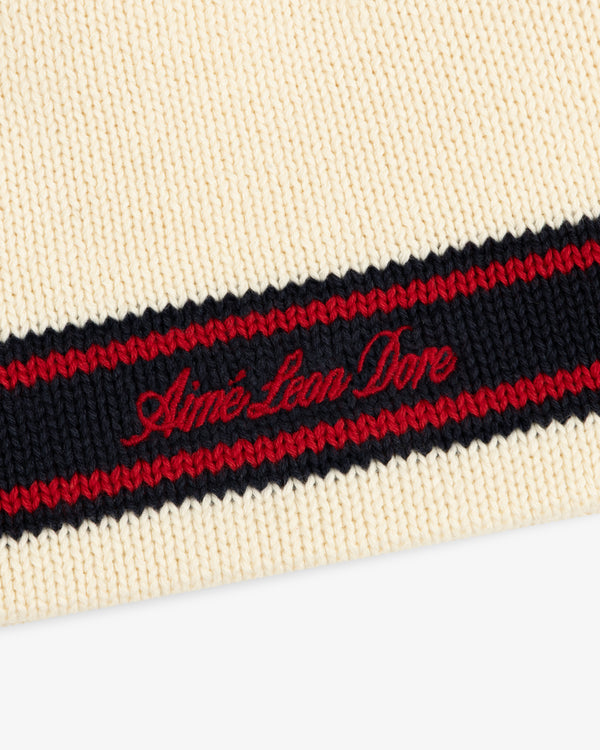 Stripe Knit Beanie in cream with black and red stripe, Aimé Leon Dore red script embroidery.