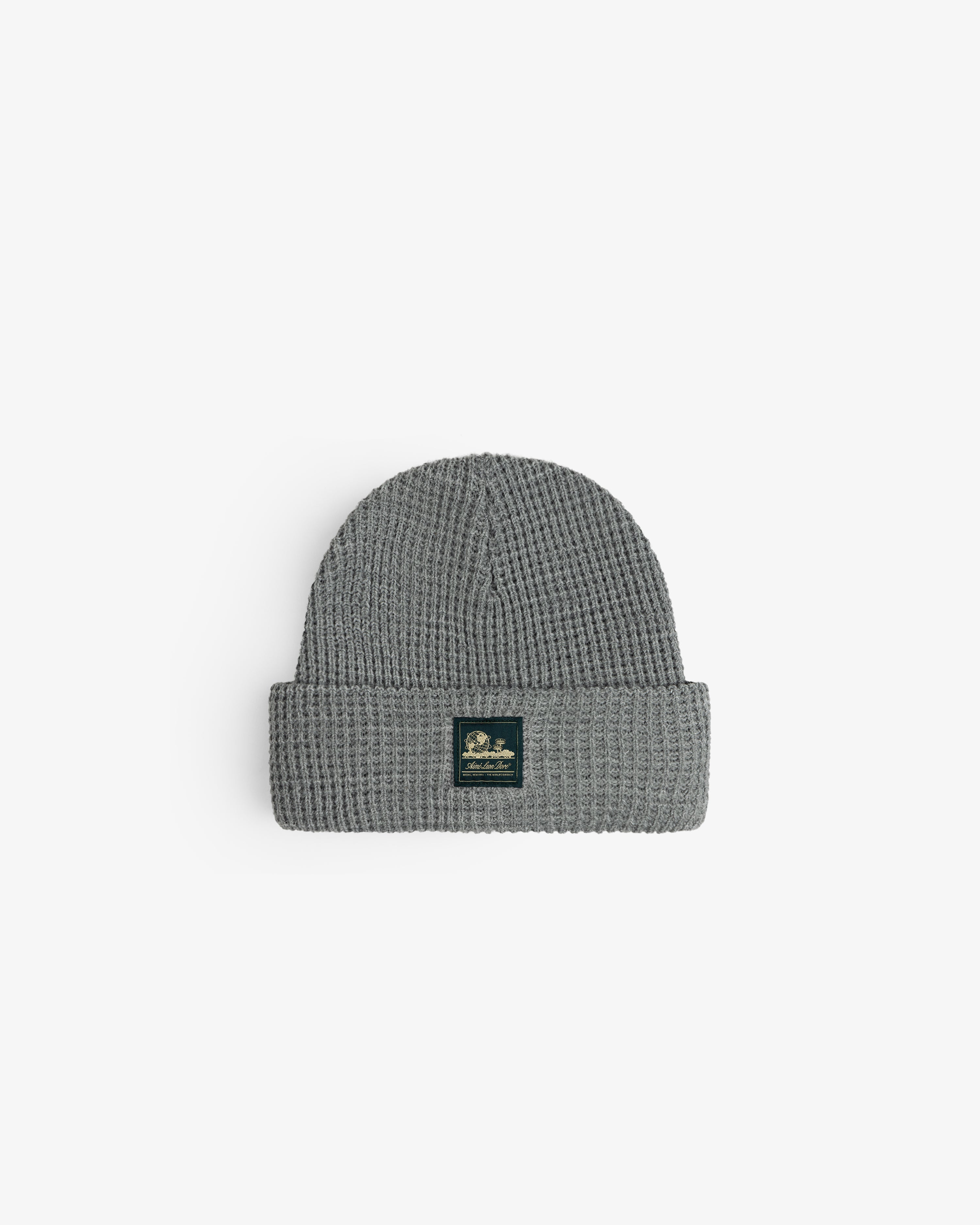 Waffle Knit Beanie in gray with folded brim and black patch, shown on a white background.