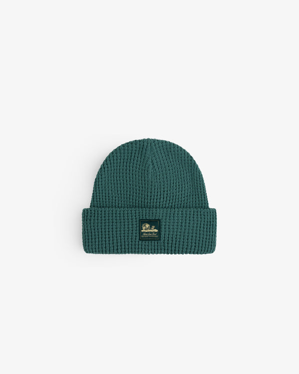 Waffle Knit Beanie in teal with a folded brim and a small black front patch.