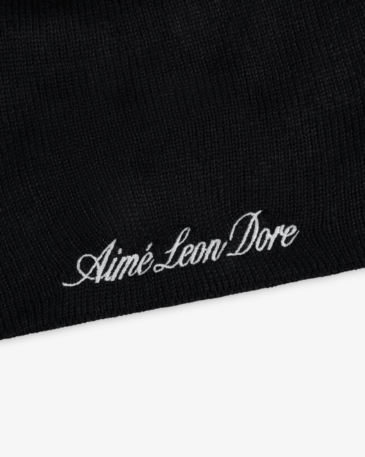 Black ALD / New Era Yankees beanie knit with embroidered white cursive text.