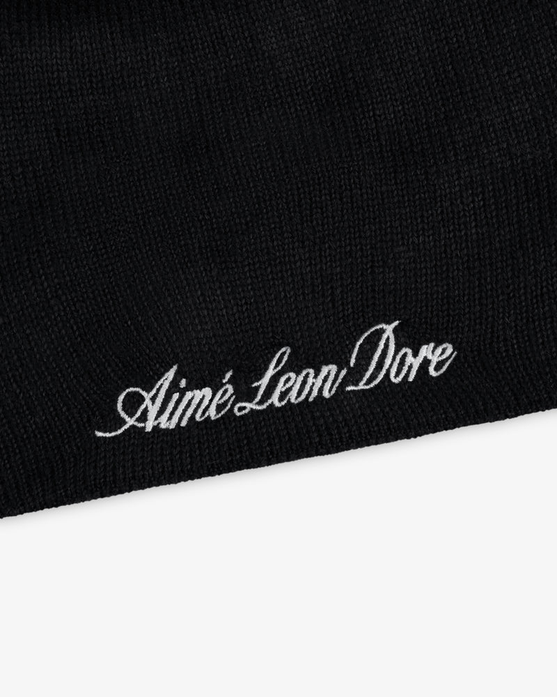 Black ALD / New Era Yankees beanie knit with embroidered white cursive text.