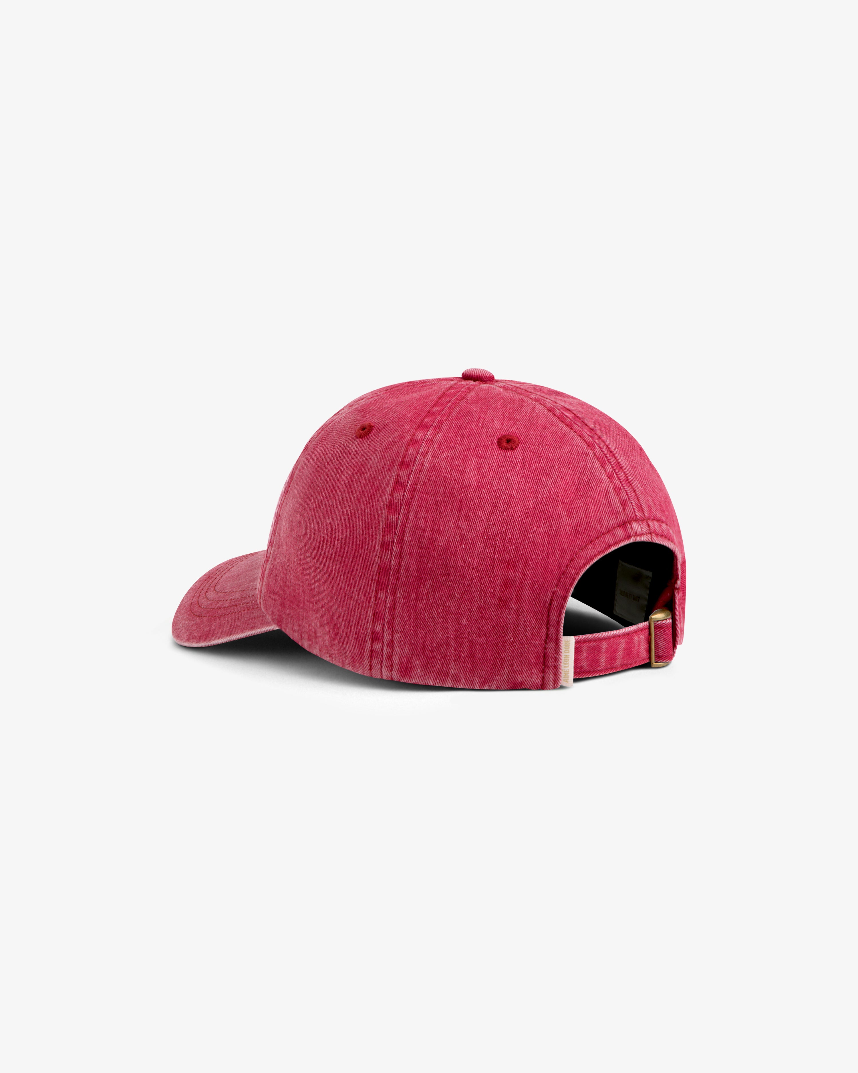 Rear view of a faded pink Aimé Retriever Hat featuring an adjustable metal strap.