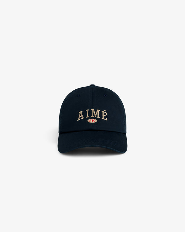 Aimé Souvenir Hat: Navy blue cap with AIMÉ and a small red NYC oval logo embroidered on the front.