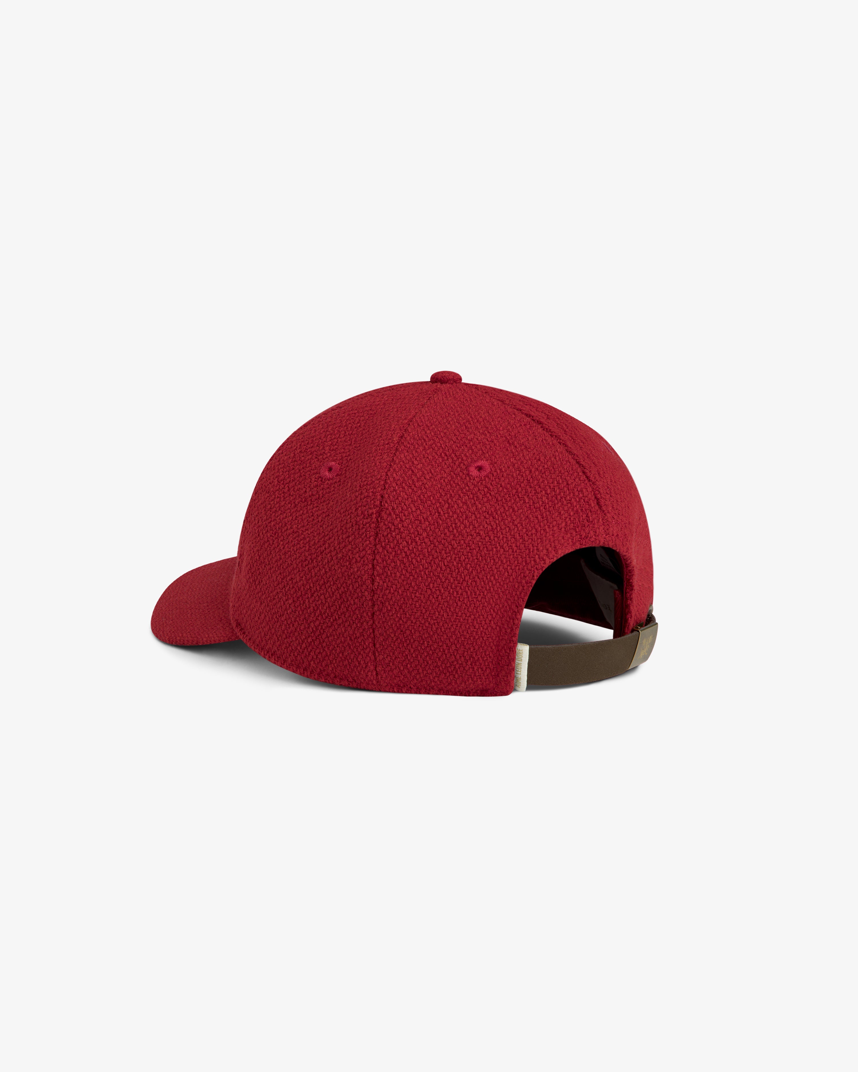 Wool Varsity Logo Hat: red baseball cap with a textured surface and an adjustable brown strap at the back.