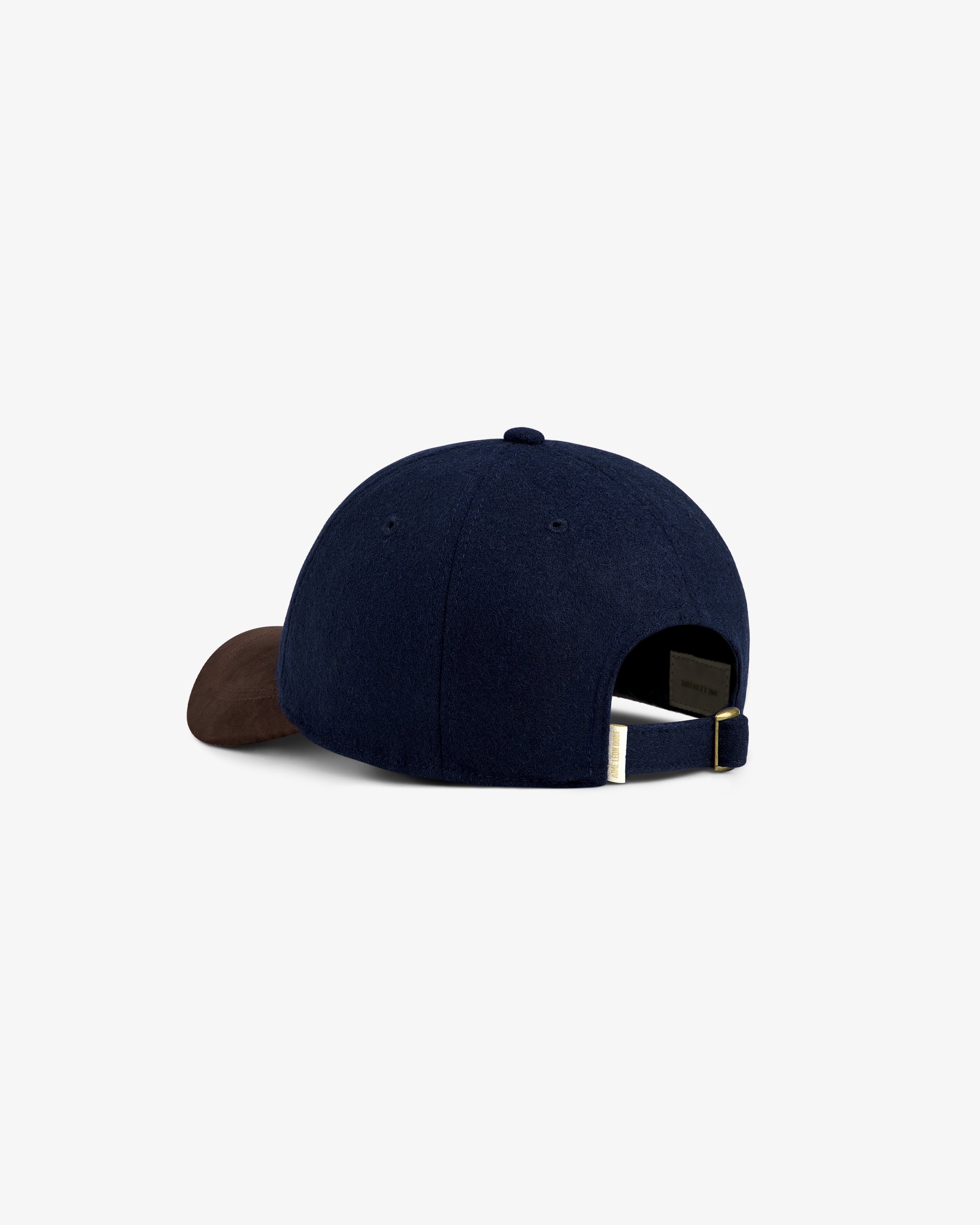 Triborough Chess Club Wool Hat in navy with brown brim, back view showing adjustable strap.