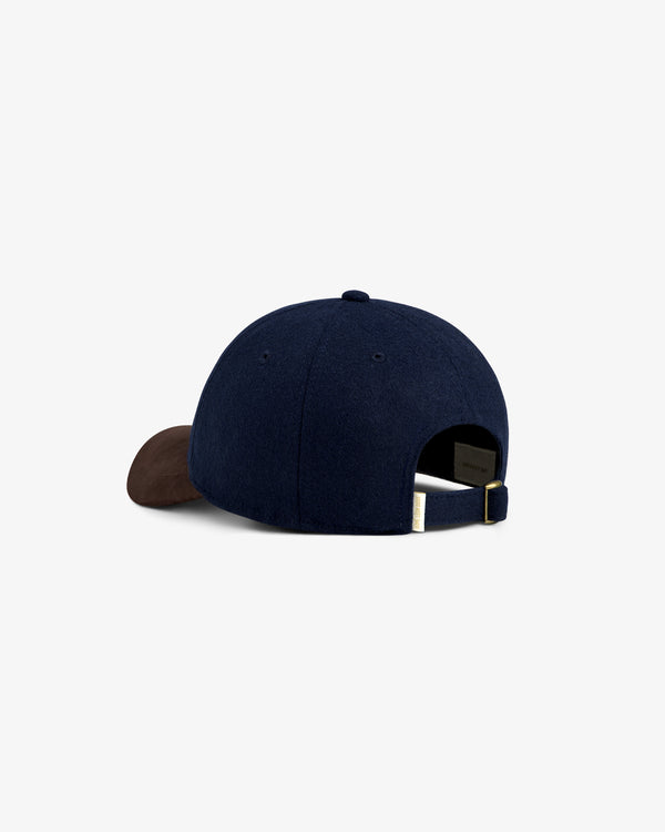 Triborough Chess Club Wool Hat in navy with brown brim, back view showing adjustable strap.
