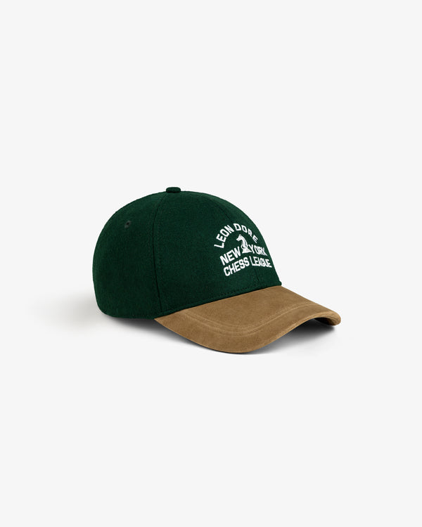A green Triborough Chess Club Wool Hat with a brown suede brim and white New York Chess League embroidery in front.
