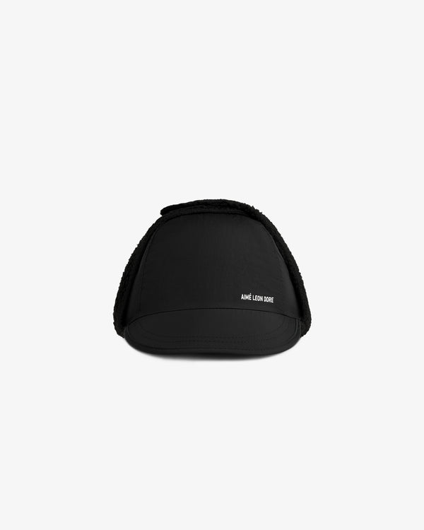 Black Fleece Lined Earflap Hat with a small brim and white logo text on the side.