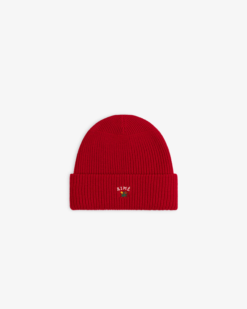 Crest Merino Wool Beanie: bright red, ribbed, folded brim, small AIME embroidery, green plant on front.