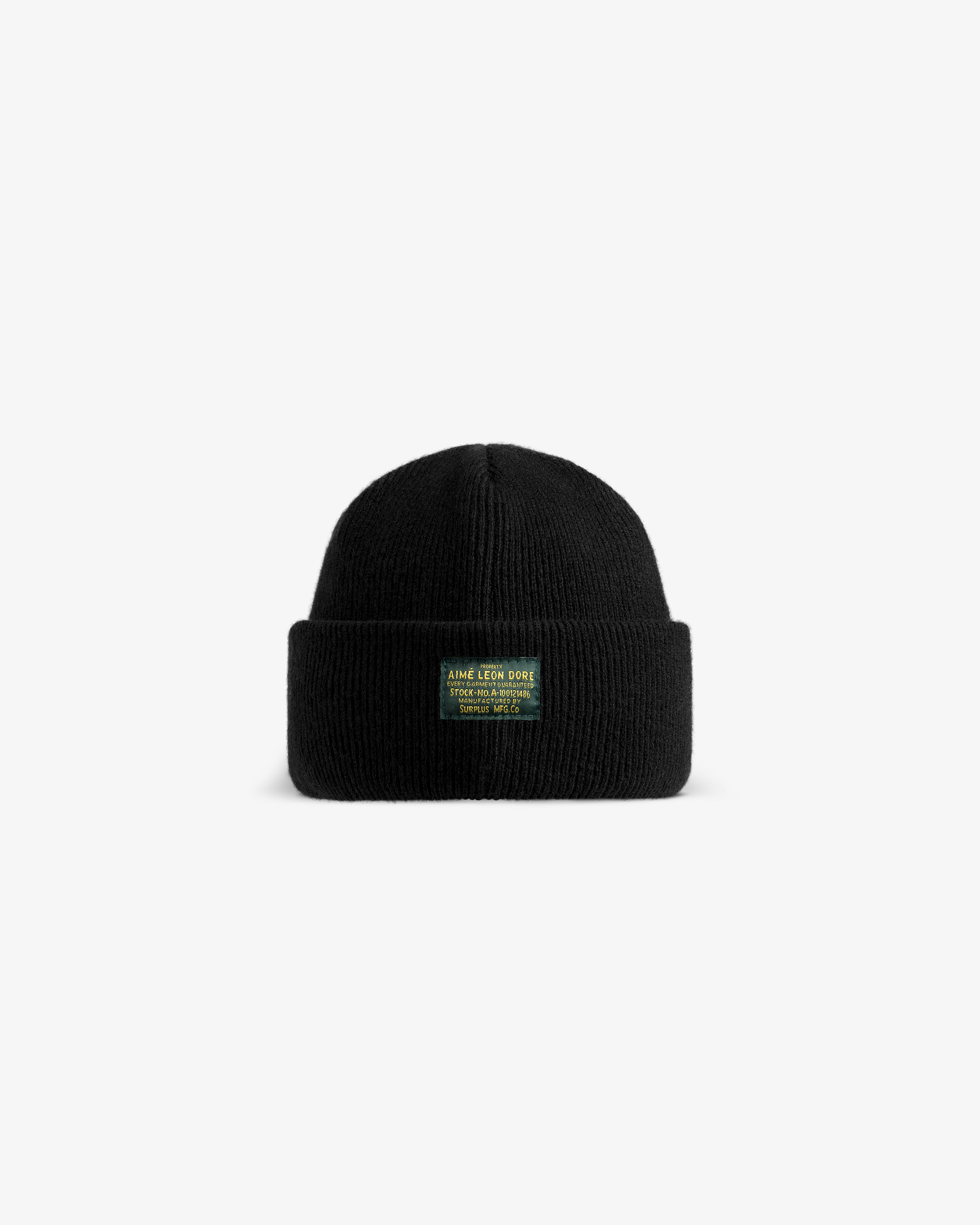 Wool Brim Beanie: a black knit beanie with a folded cuff and a green rectangular patch featuring yellow text.