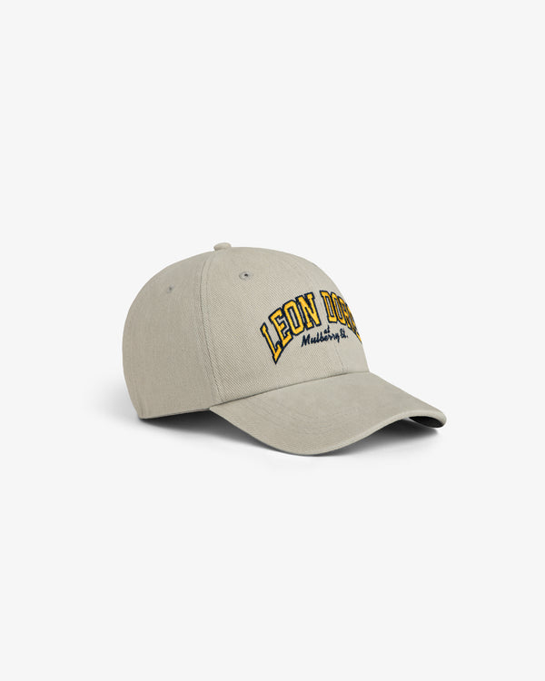 Mulberry Letterman Hat in beige with LEON DORE and small yellow & black text embroidered on the front.
