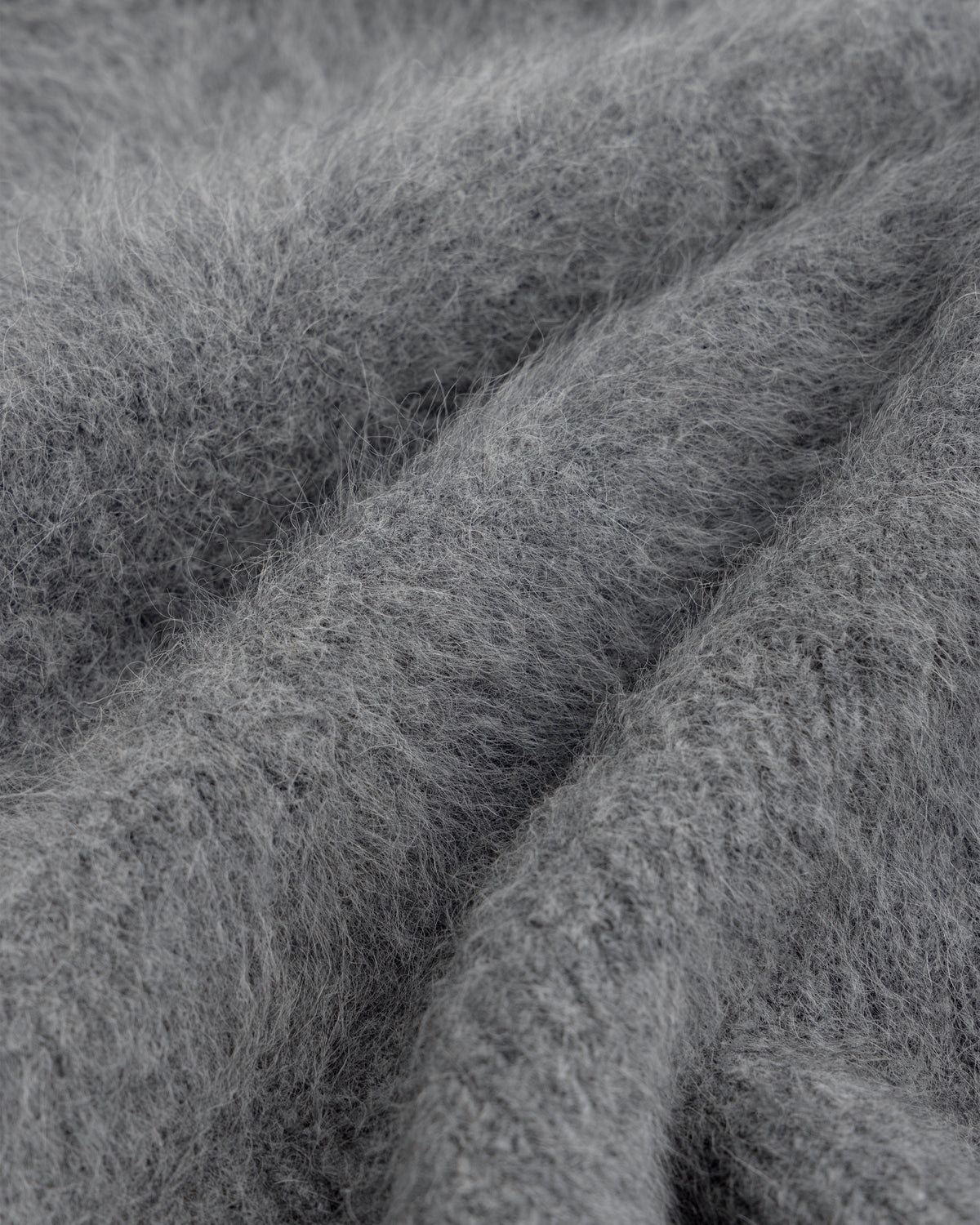 Close-up of a soft, gray, fuzzy Fox Fur Hood with deep folds.