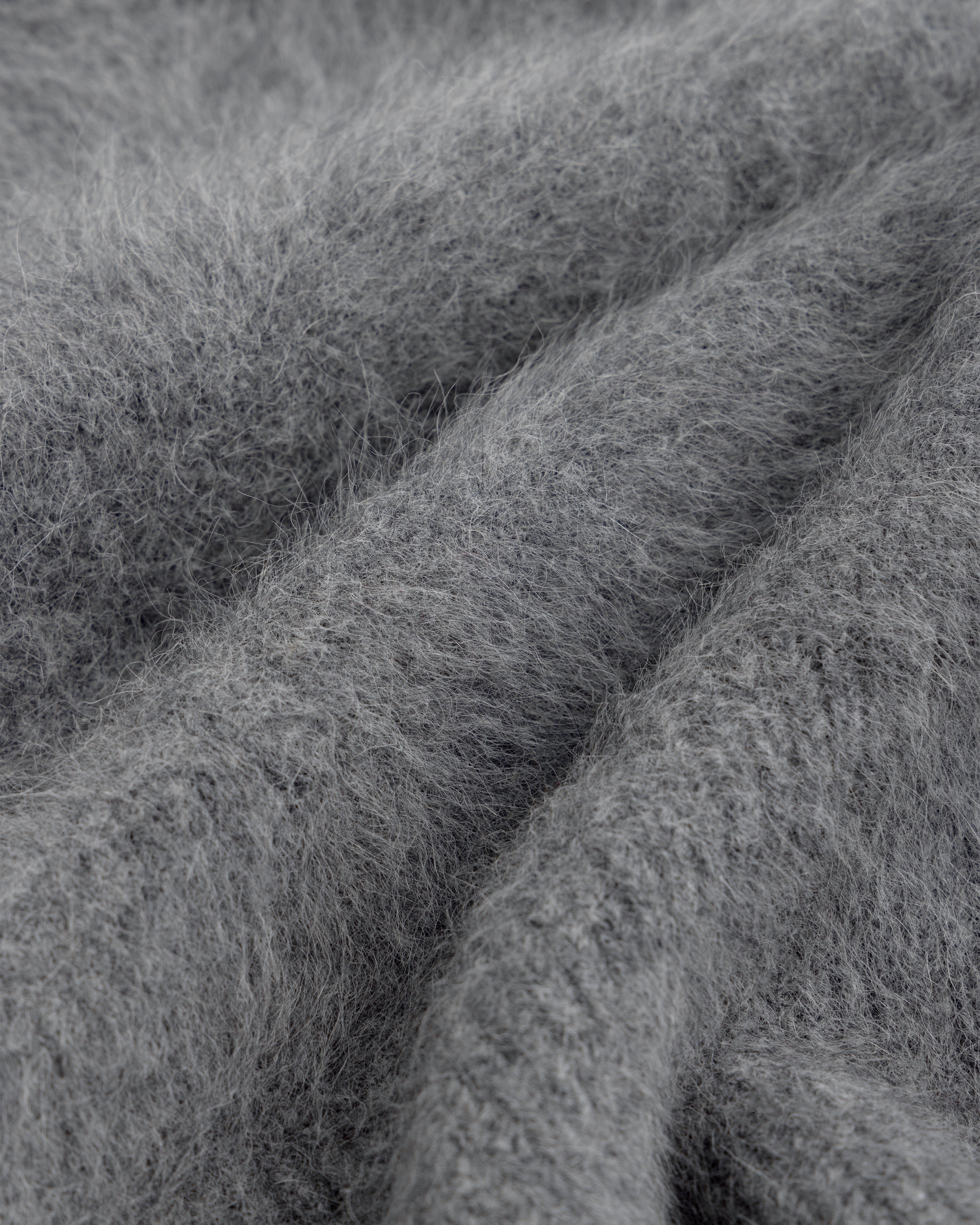 Close-up of a soft, gray, fuzzy Fox Fur Hood with deep folds.