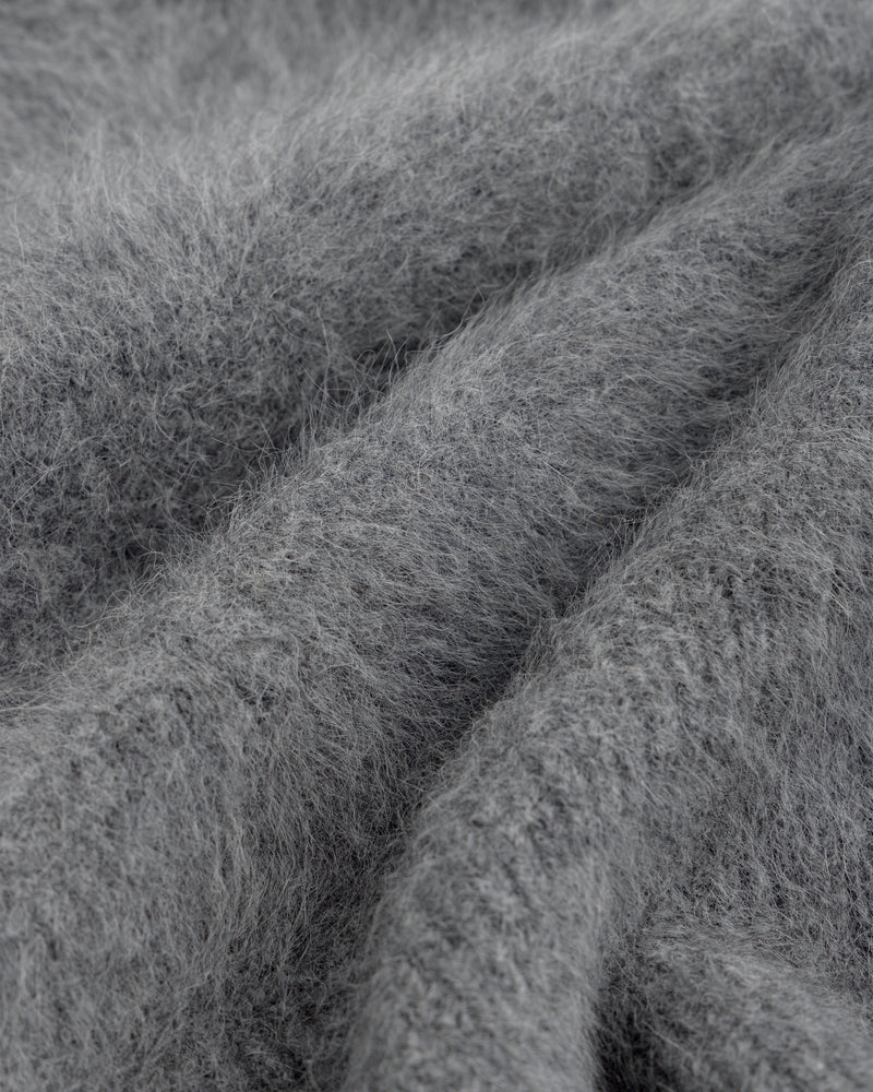 Close-up of a soft, gray, fuzzy Fox Fur Hood with deep folds.