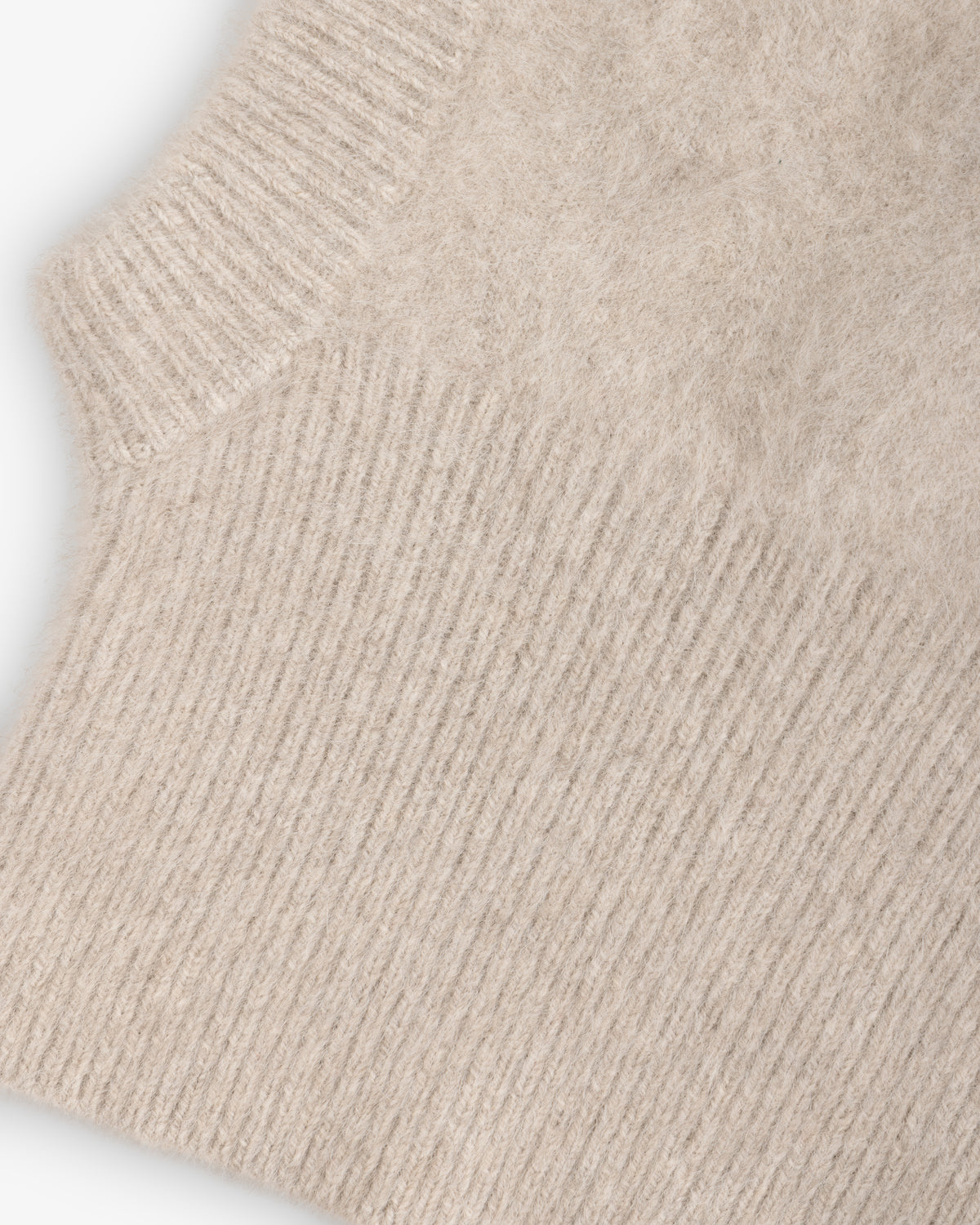 Beige fuzzy Fox Fur Hood with a ribbed trim.