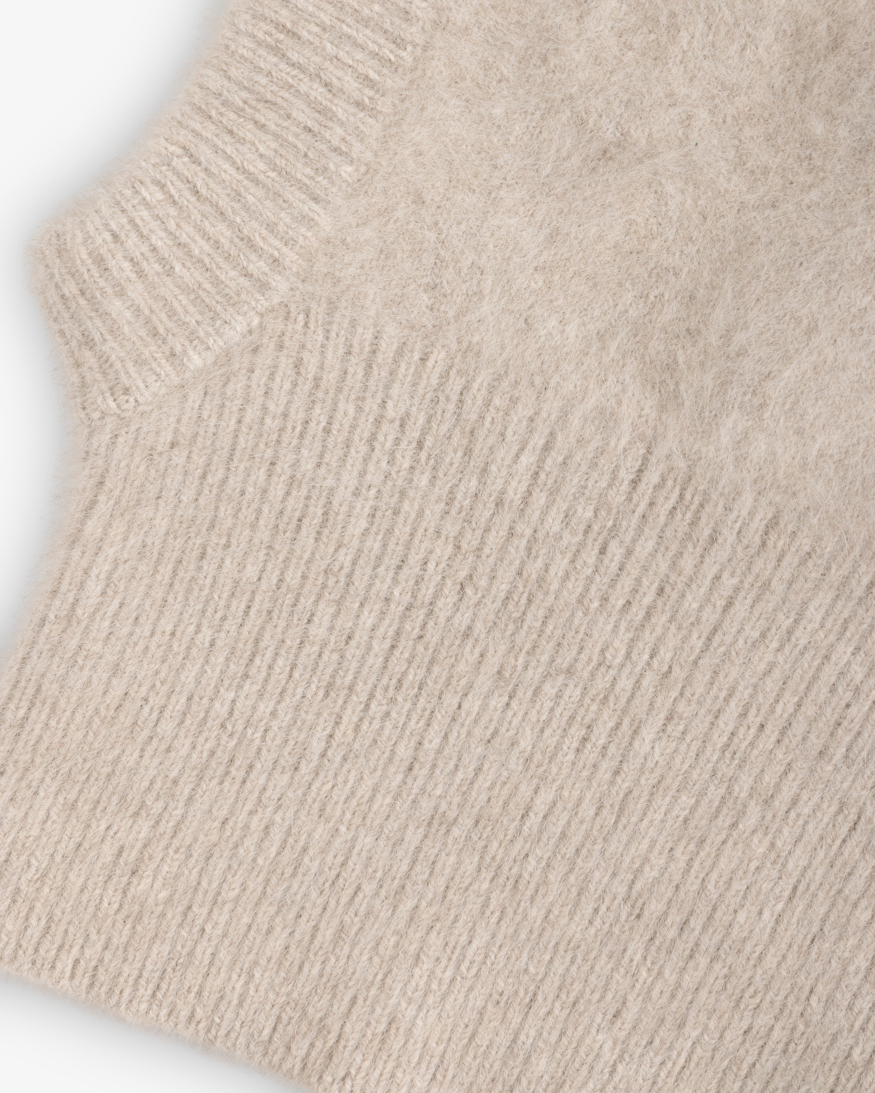 Beige fuzzy Fox Fur Hood with a ribbed trim.