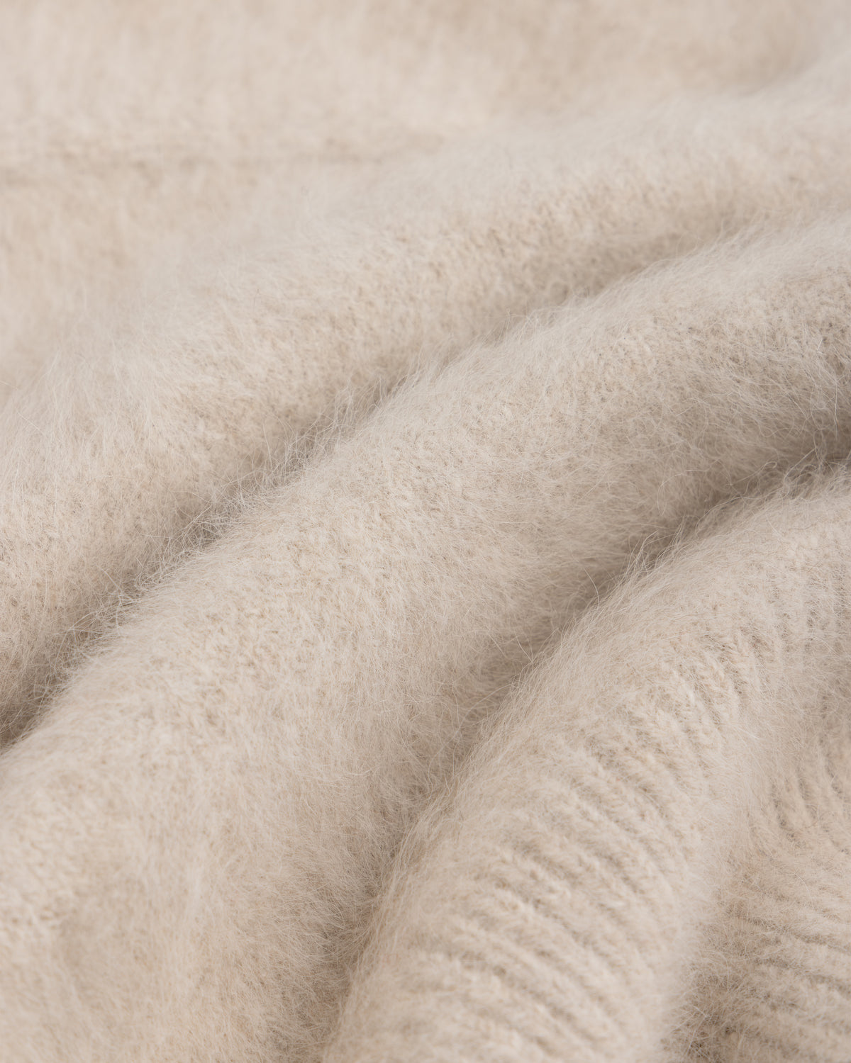 Close-up of a soft, beige, fuzzy-textured Fox Fur Hood.