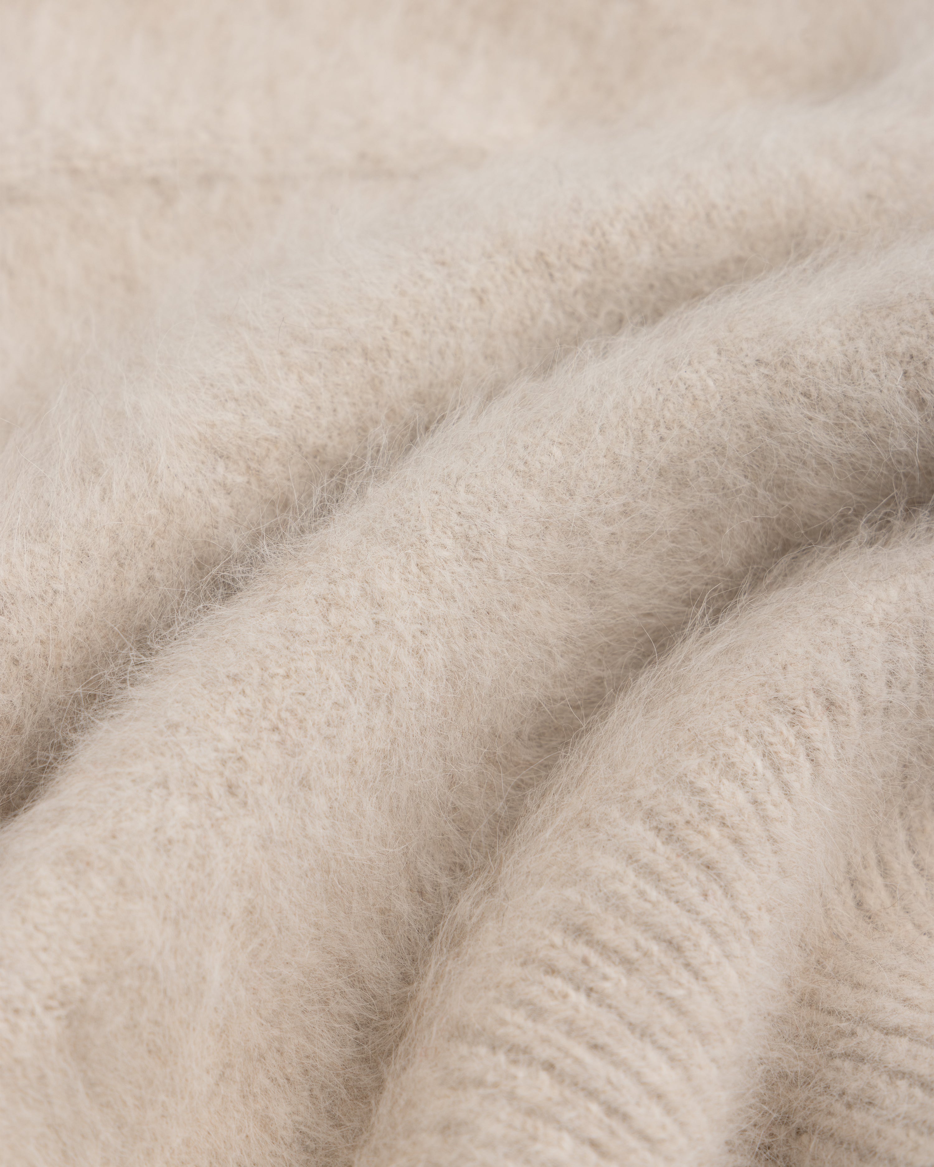 Close-up of a soft, beige, fuzzy-textured Fox Fur Hood.
