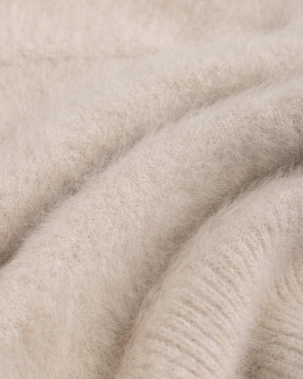 Close-up of a soft, beige, fuzzy-textured Fox Fur Hood.