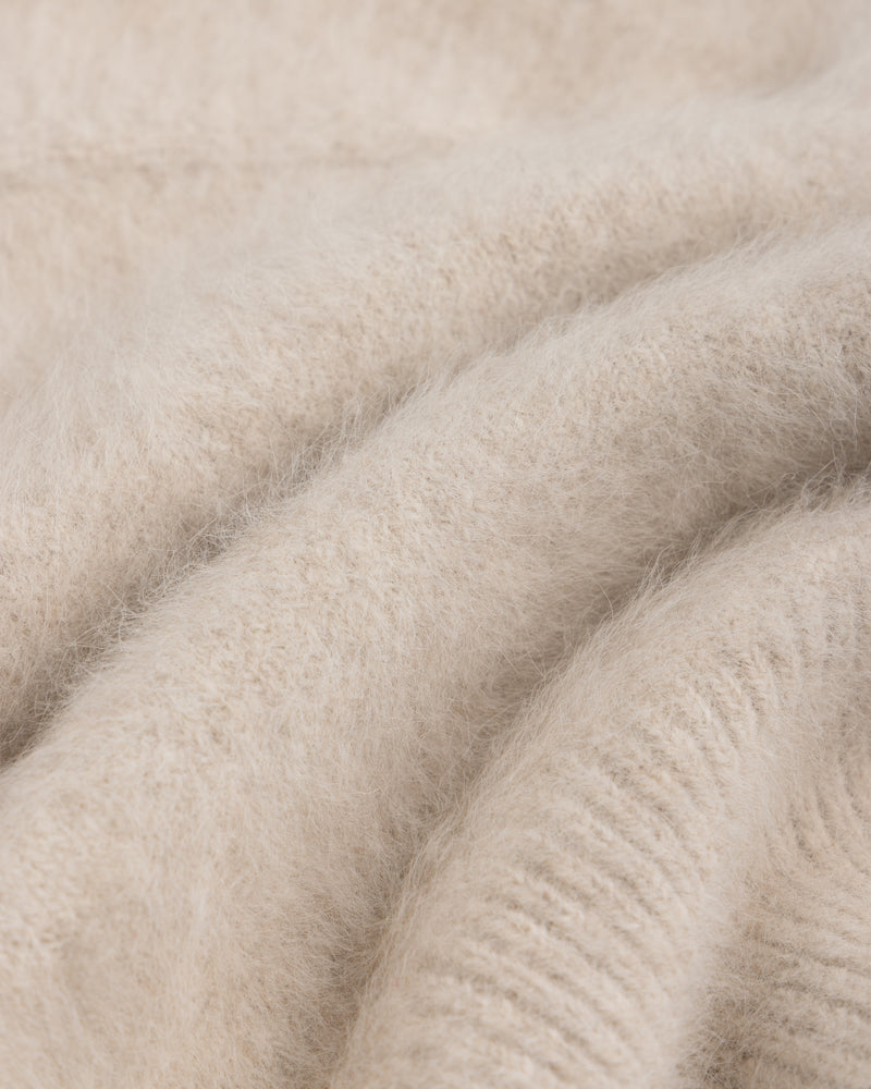 Close-up of a soft, beige, fuzzy-textured Fox Fur Hood.