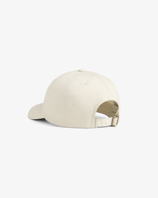 The Stacked Logo Hat in beige, shown from the back with an adjustable strap and metal clasp.