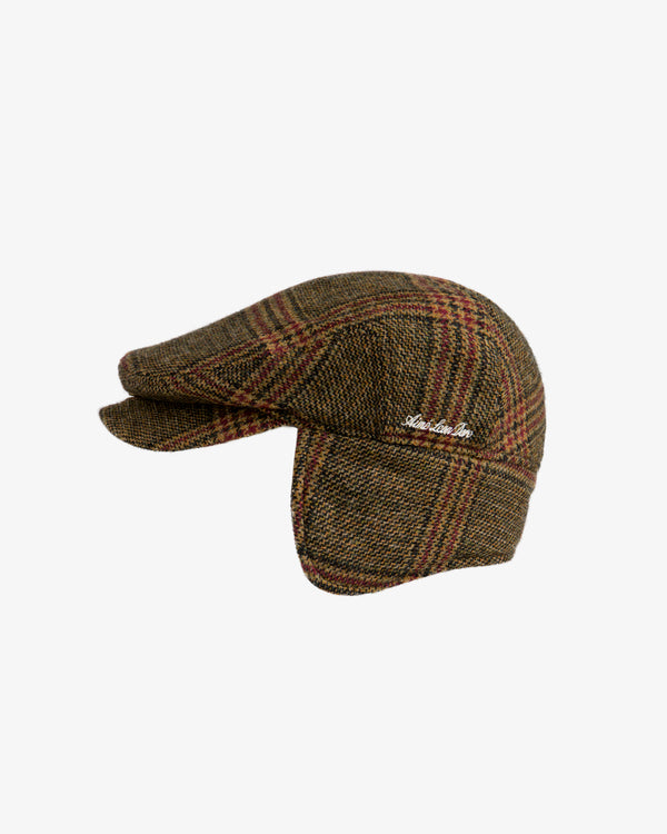 Brown plaid tweed Plaid Tweed Driver’s Hat with side flaps and embroidered white script.