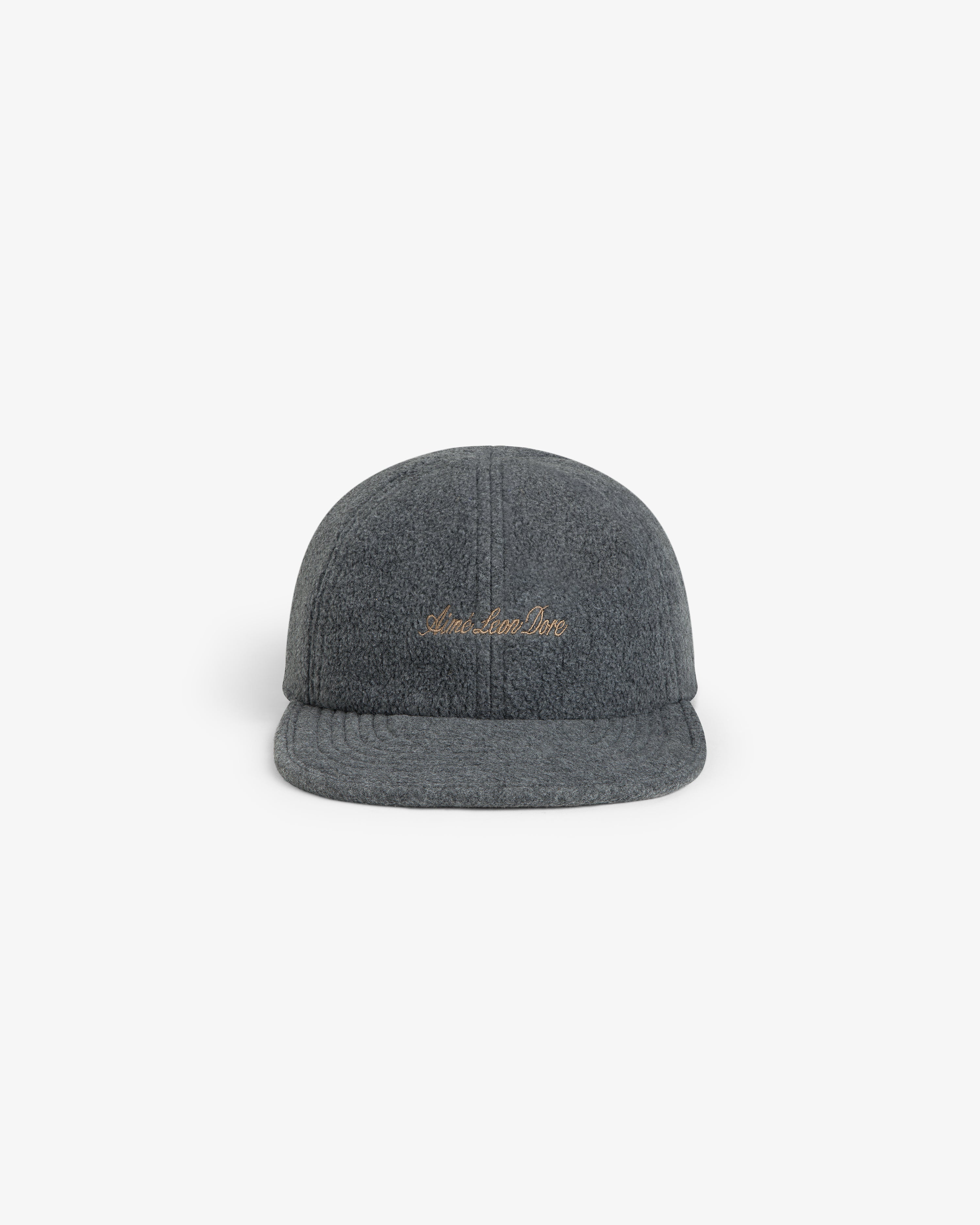 Script Fleece Hat in charcoal grey with cursive gold embroidery on the front.