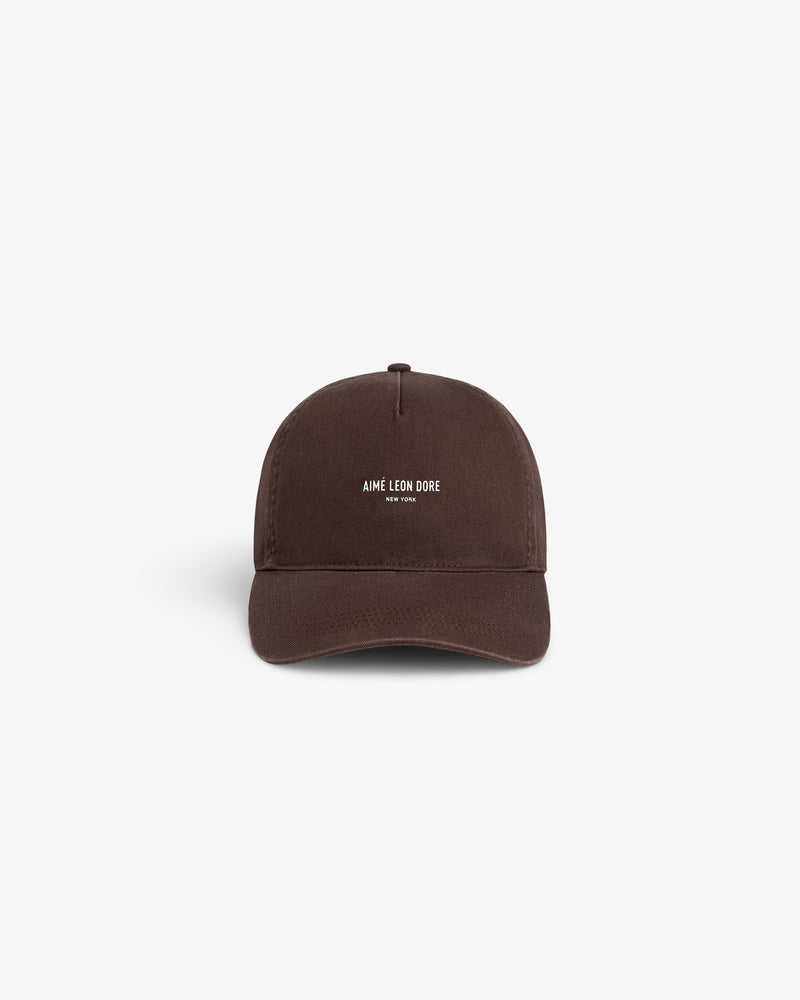 Brown Micro Logo Hat featuring AIMÉ LEON DORE NEW YORK text embroidered in white, centered on the front.