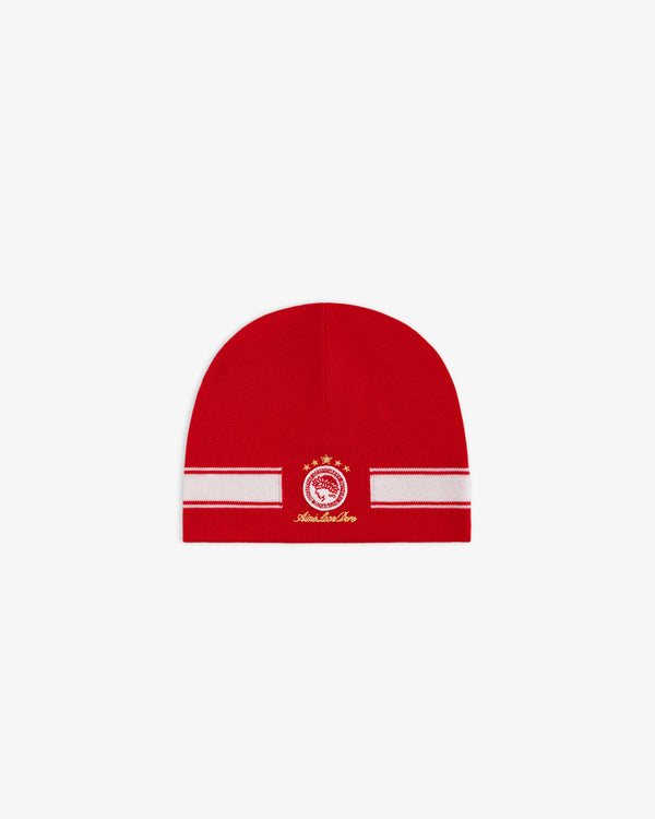 ALD / Olympiacos F.C. Stadium Beanie, a red beanie with a white horizontal stripe and a circular team crest in gold.