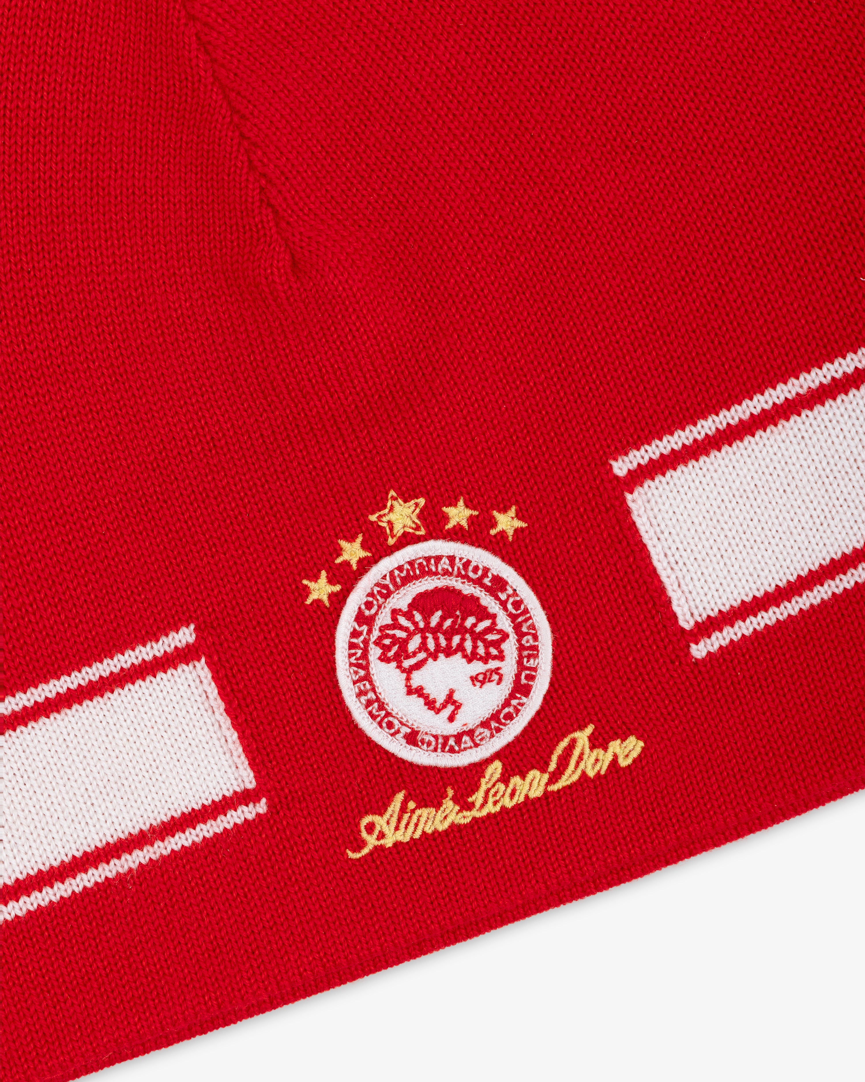 ALD / Olympiacos F.C. Stadium Beanie: red knit hat with white stripe and circular club crest featuring four gold stars.