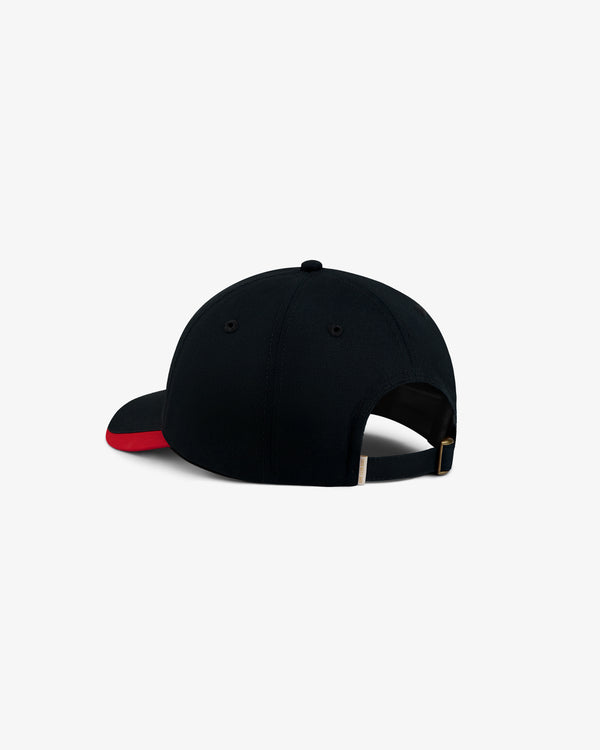 Back view of an ALD / Olympiacos F.C. Souvenir Hat, a black baseball cap with a red brim and adjustable gold-tone strap.